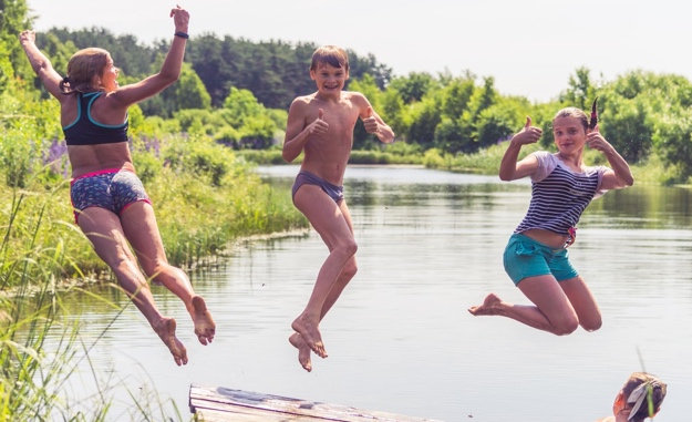 Children jumping into water